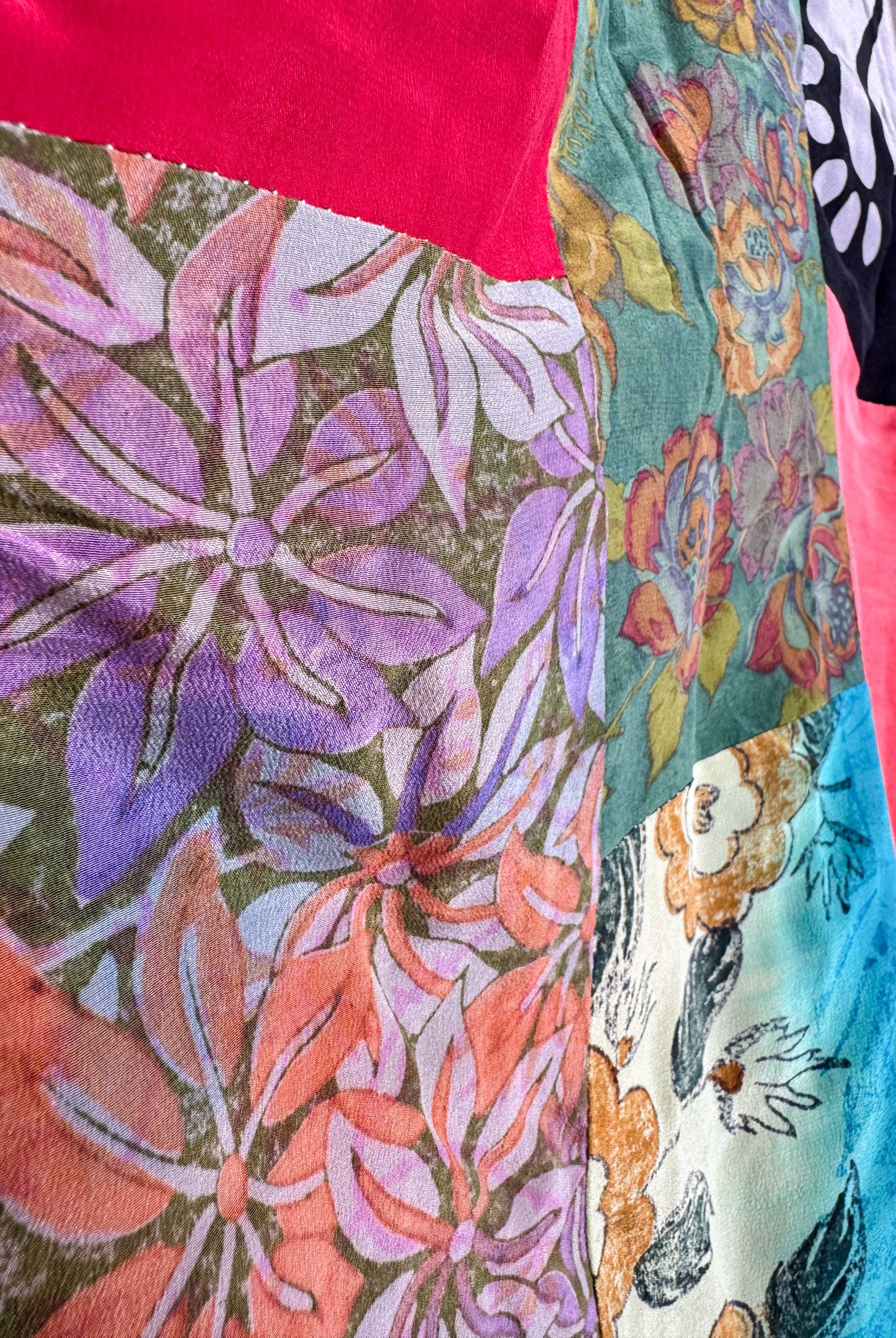 Close-up of colorful fabric with floral patterns and a dog illustration - Love Protect Sustain
