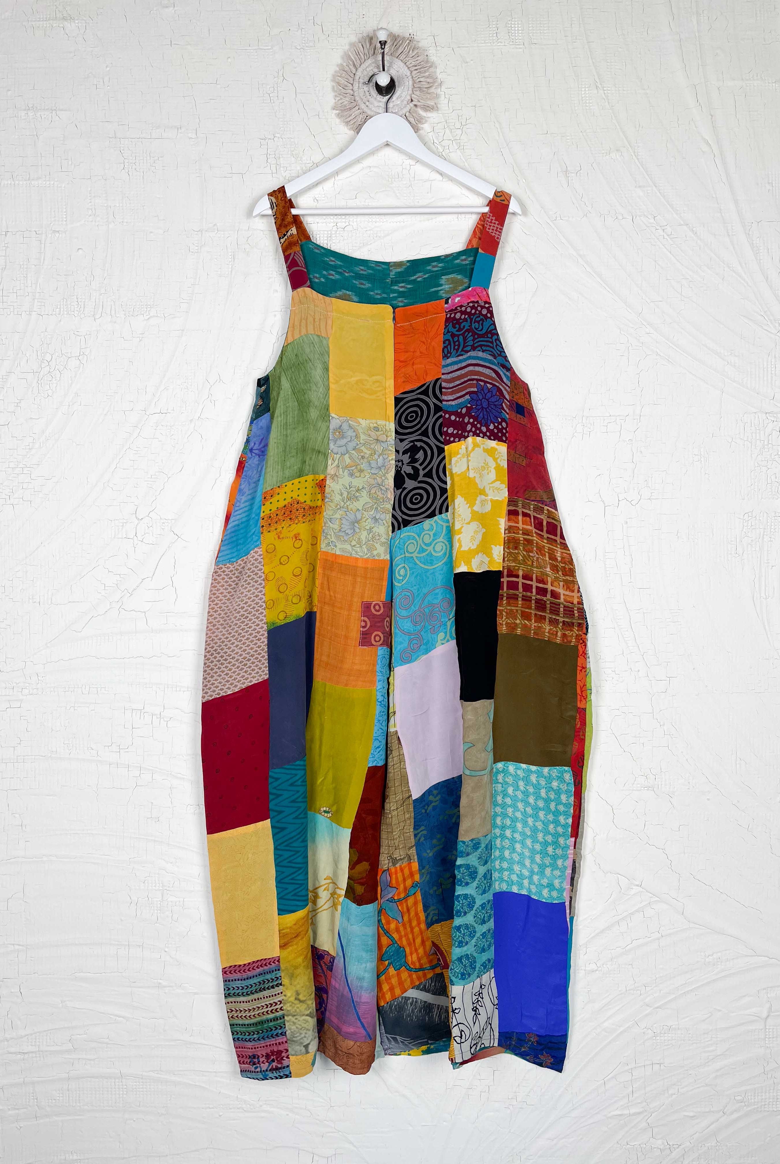 Colorful patchwork dress hanging on a white wall - Love Protect Sustain
