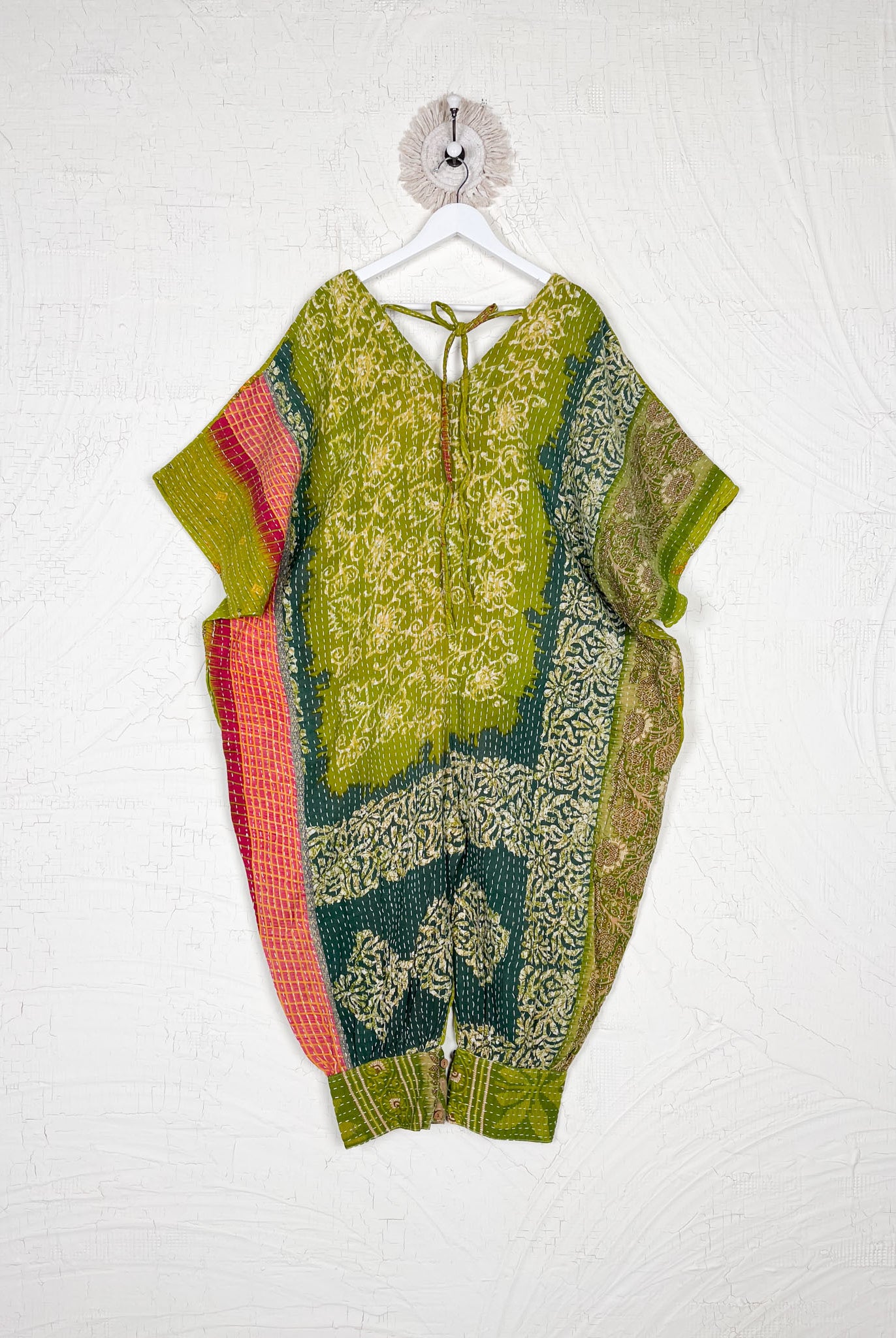 Colorful patterned outfit on a hanger against a white background - Love Protect Sustain