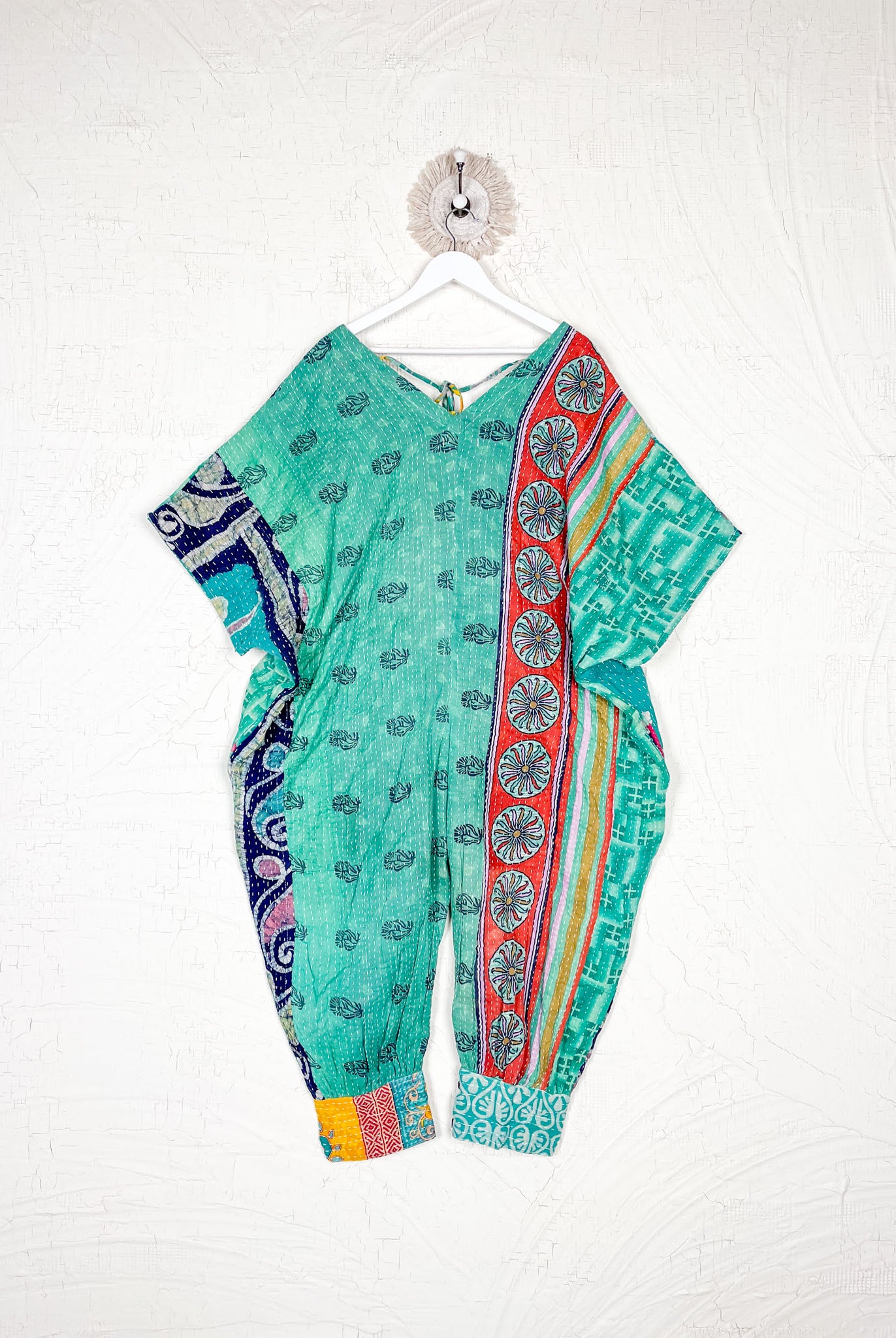 Colorful traditional outfit with patterns on a white background - Love Protect Sustain
