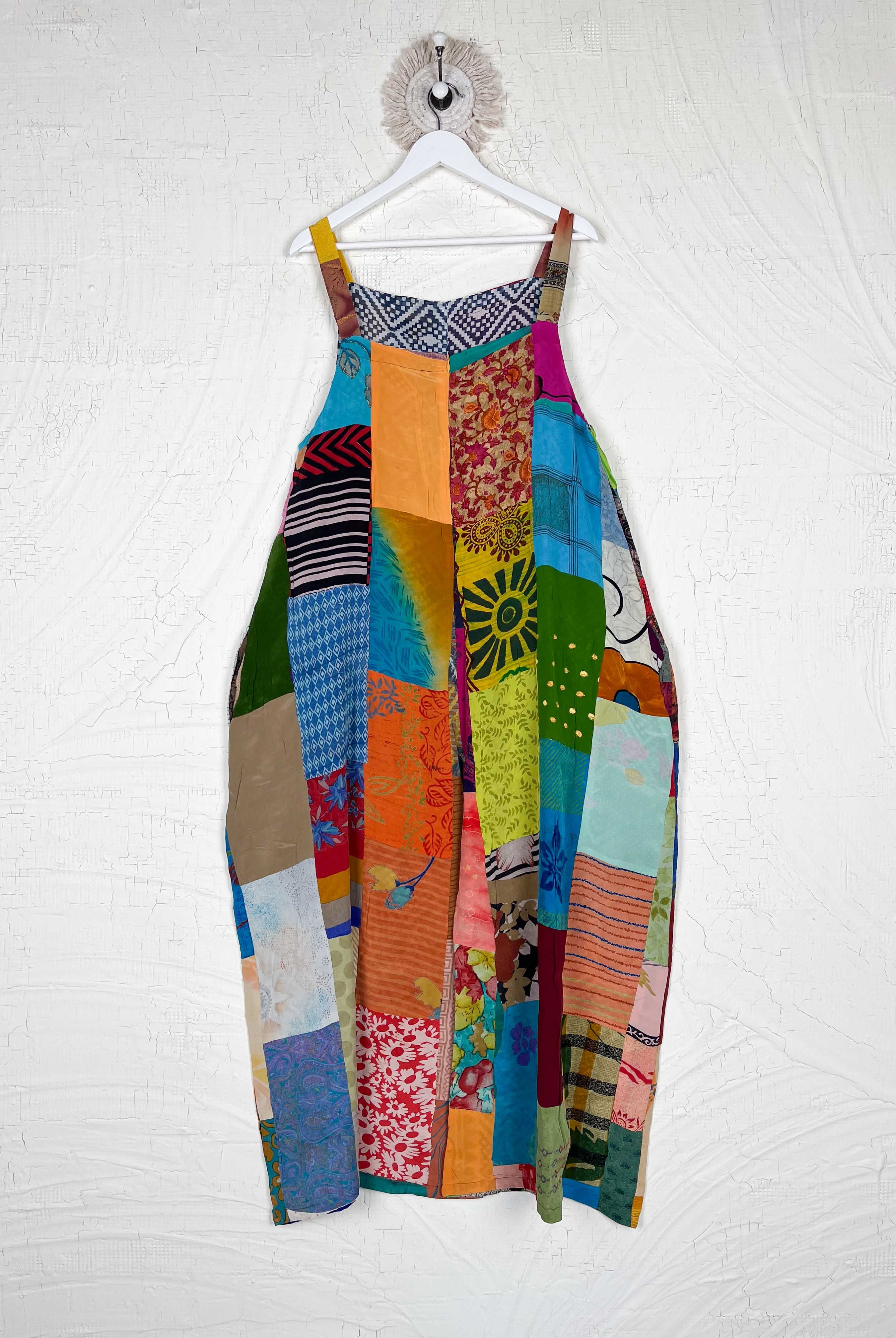 Colorful patchwork jumpsuit on a white wall - Love Protect Sustain