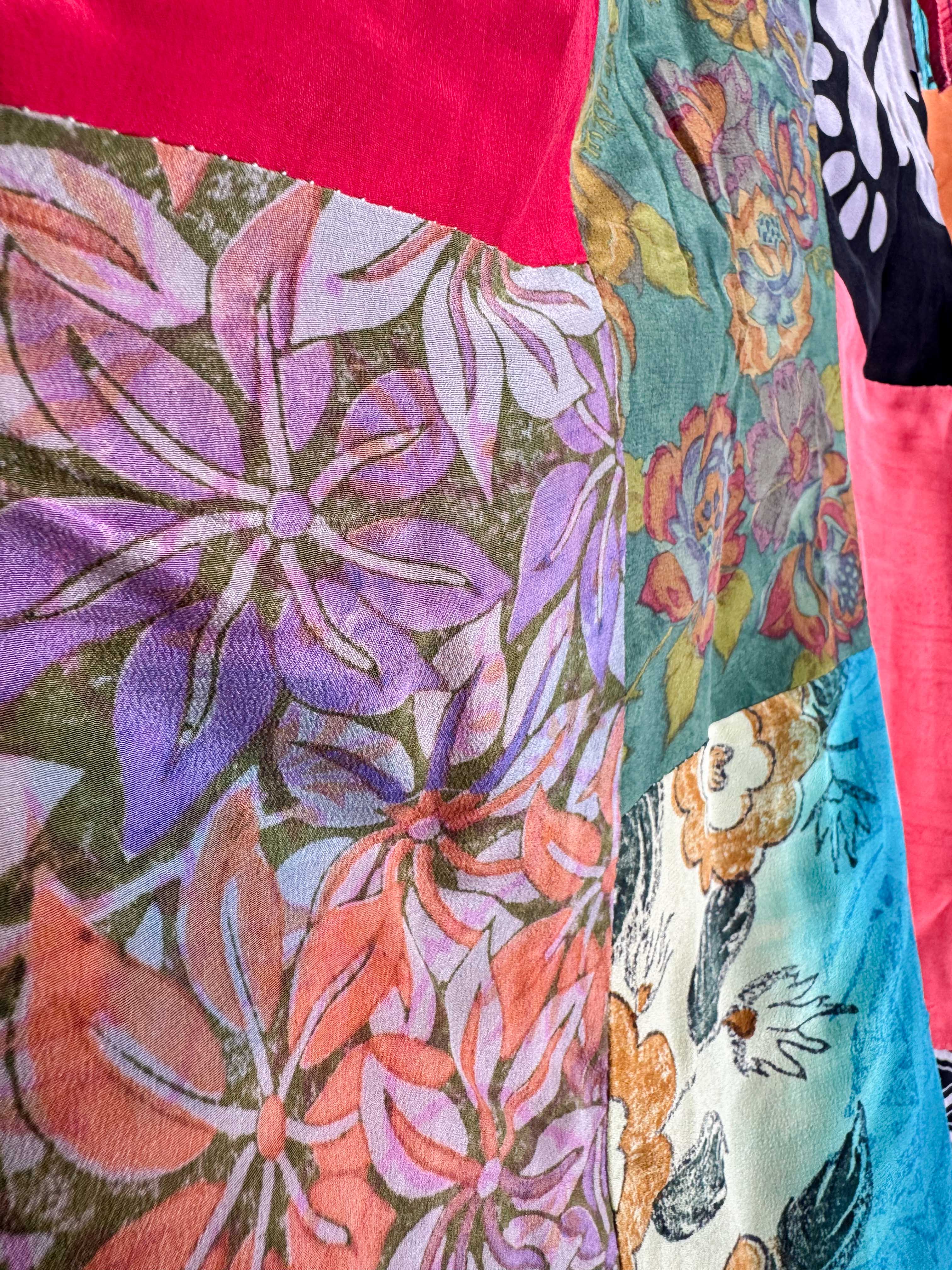 Close-up of colorful fabric with floral patterns and a dog illustration - Love Protect Sustain