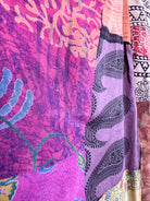 Close-up of colorful fabric with patterns including paisley and abstract designs - Love Protect Sustain