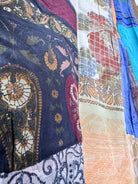 Close-up of various patterned fabrics with intricate designs - Love Protect Sustain