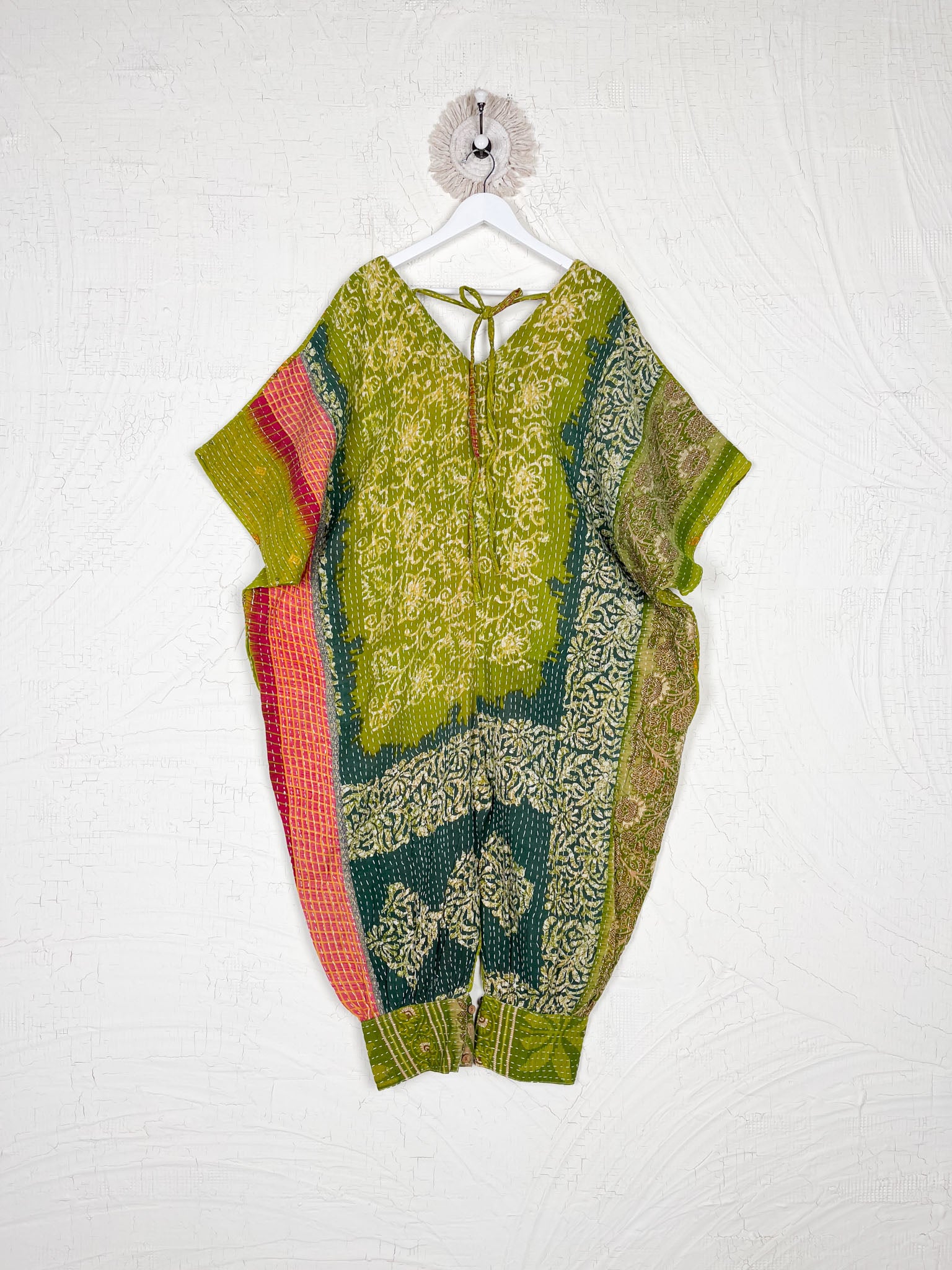 Colorful patterned outfit on a hanger against a white background - Love Protect Sustain