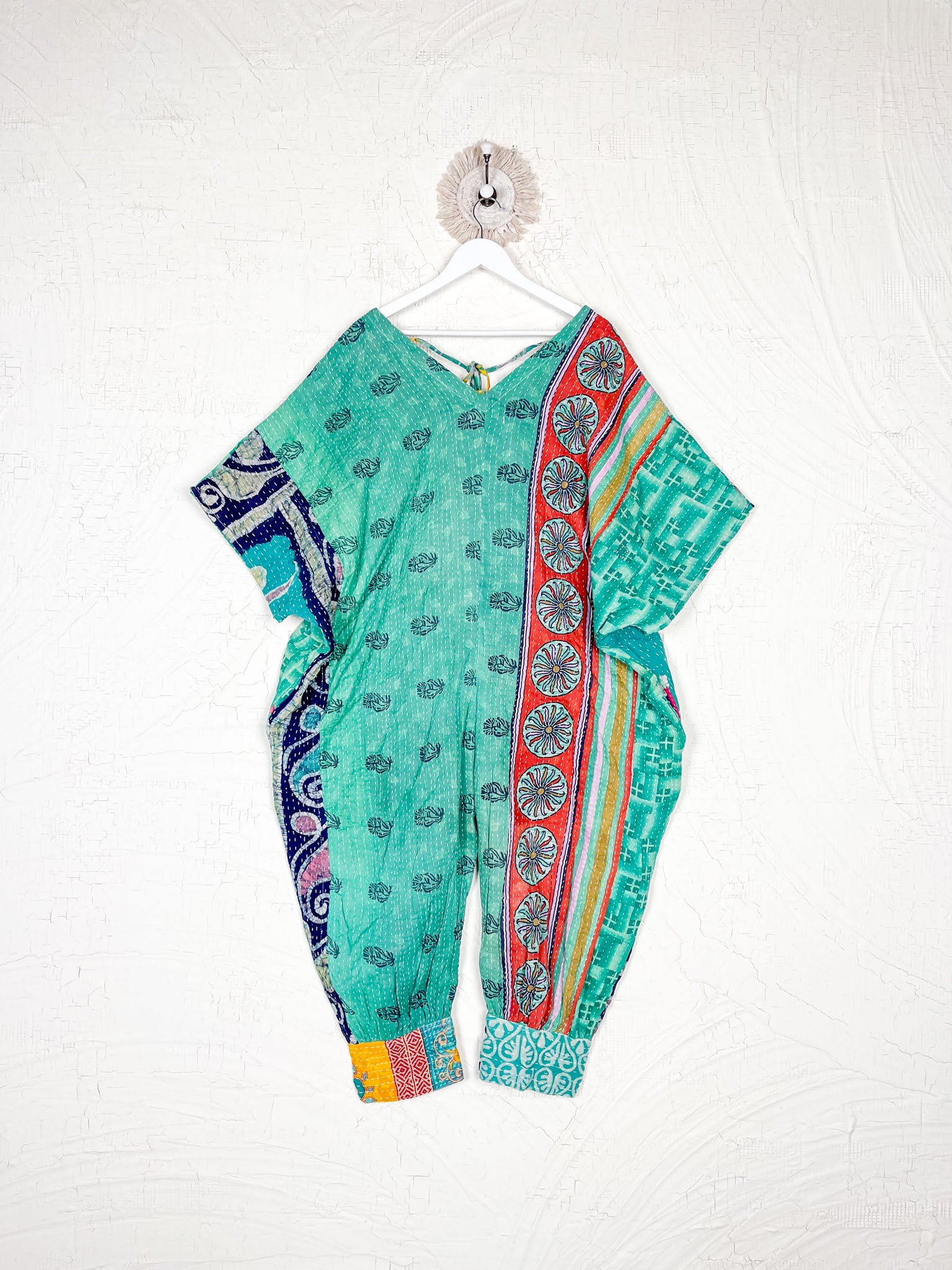 Colorful traditional outfit with patterns on a white background - Love Protect Sustain